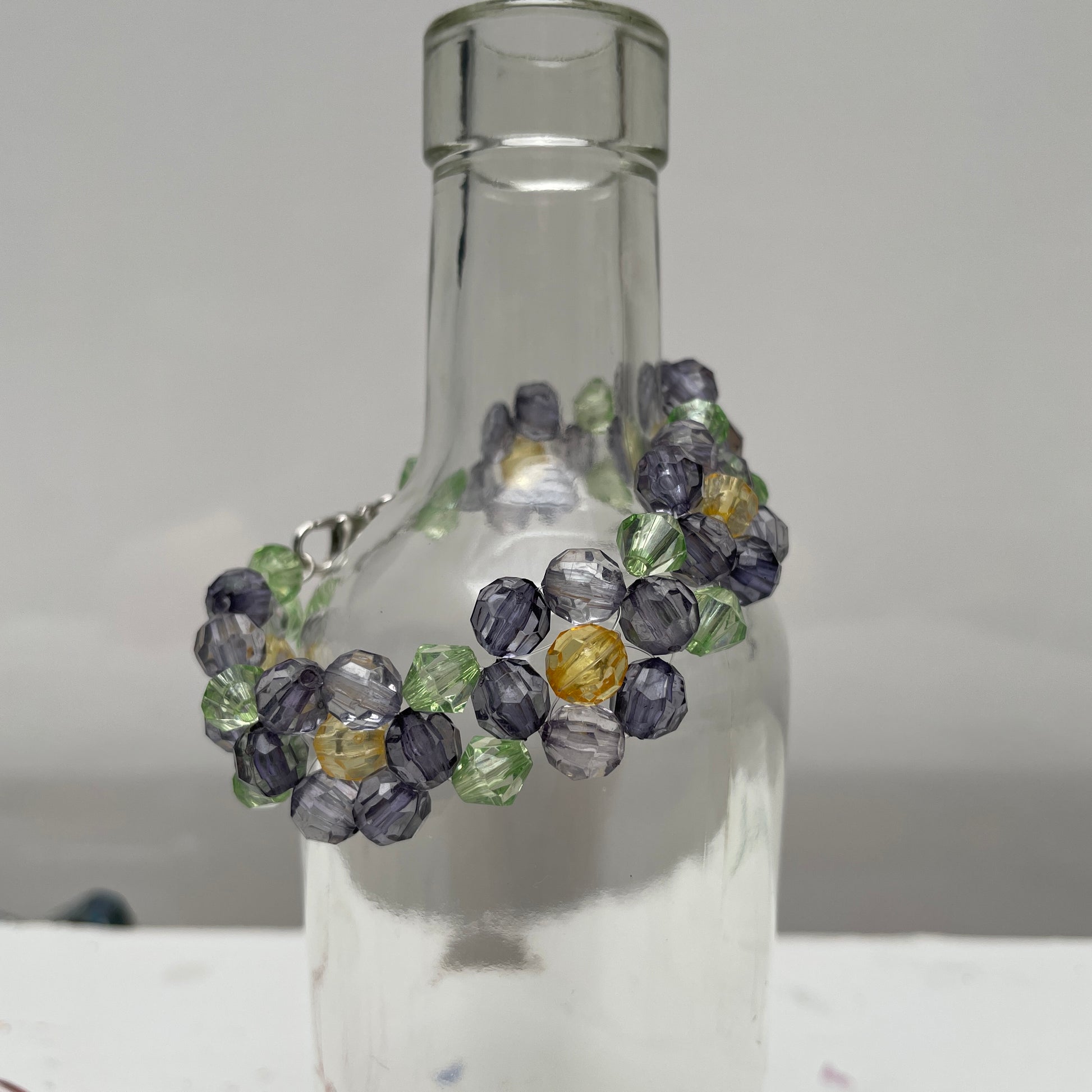 red flower bracelet made with acrylic beads. Designed by Maggie McKeever